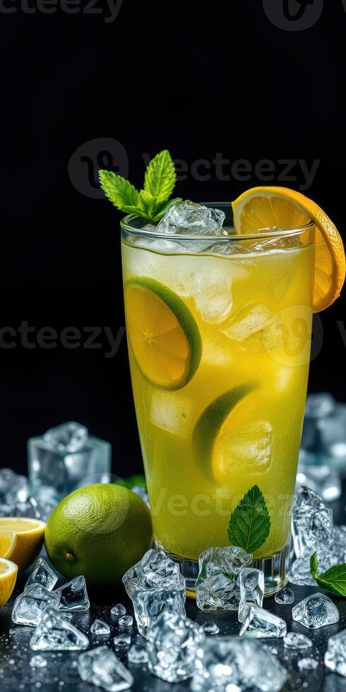 Refreshing citrus beverage garnished with mint and lime on a dark background with ice cubes photo