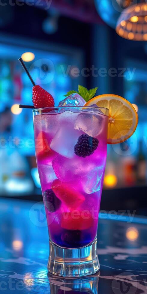 Refreshing purple cocktail garnished with fruits served in a vibrant bar setting at night photo
