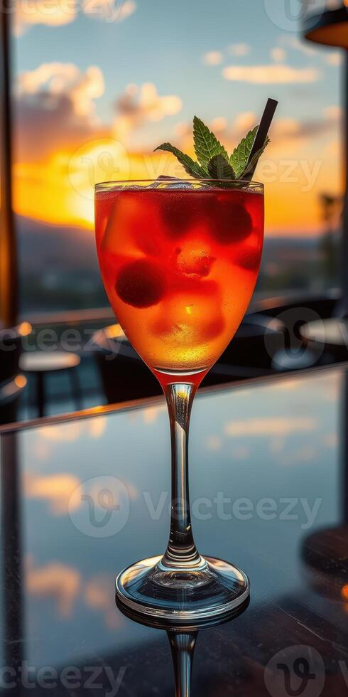 Bright cocktail with cherries and mint against a sunset backdrop in a lively bar setting photo