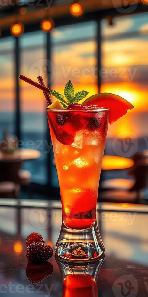 Vibrant cocktail garnished with mint and fruit against a stunning sunset backdrop photo