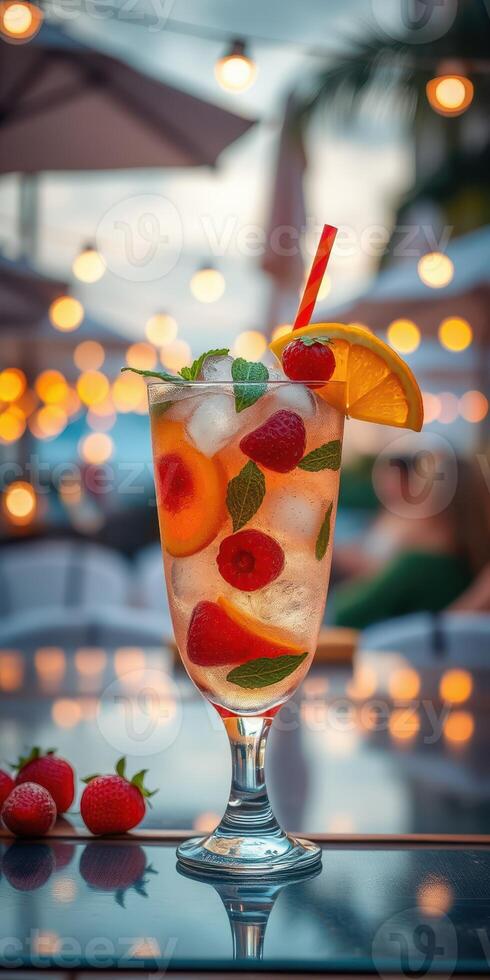 Refreshing fruit cocktail served at sunset during a lively outdoor gathering with soft lights and warm atmosphere photo