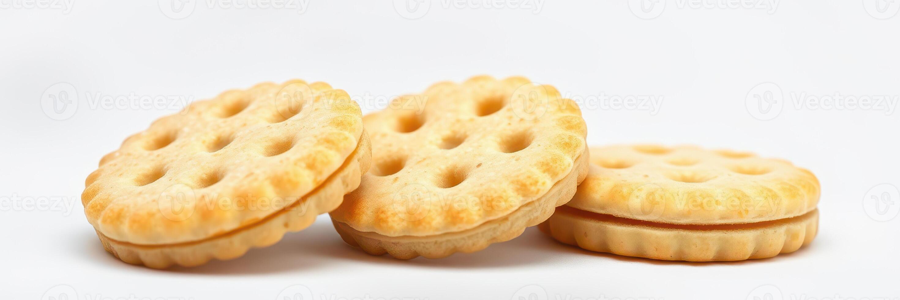 Delicious round cookies with cream filling stacked on a white background in a simple setting photo