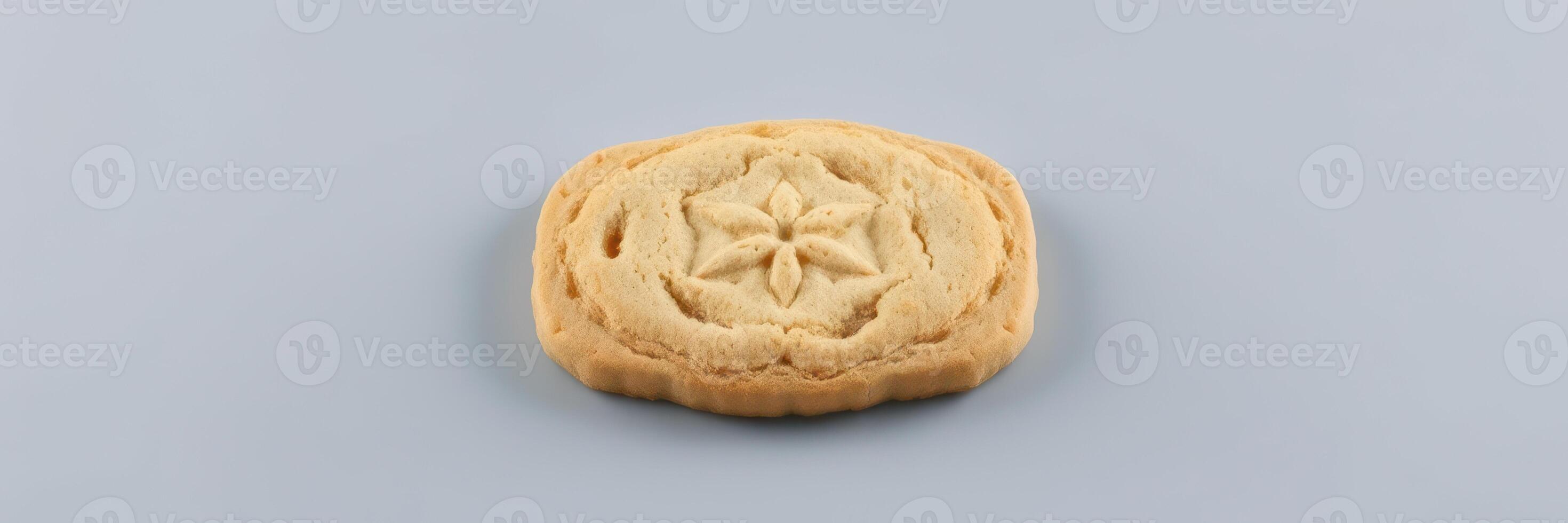 Detailed view of a freshly baked cookie showcasing intricate design and golden color photo