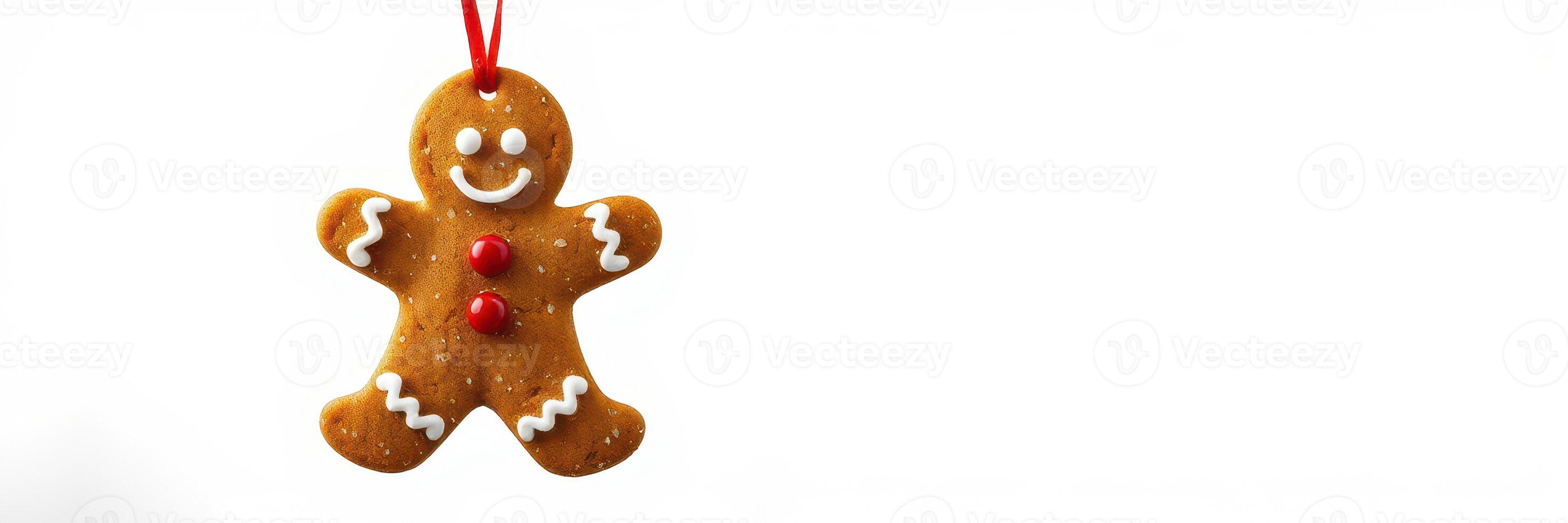 Gingerbread man ornament hanging on a red string ready for holiday decoration photo