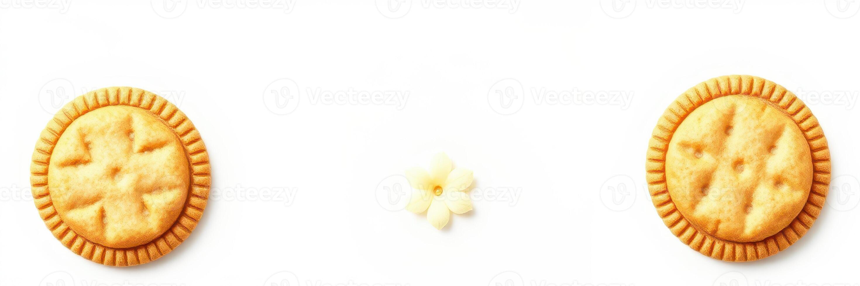 Delicious cookies arranged on a white background with a small flower as decoration during a sweet treat moment photo