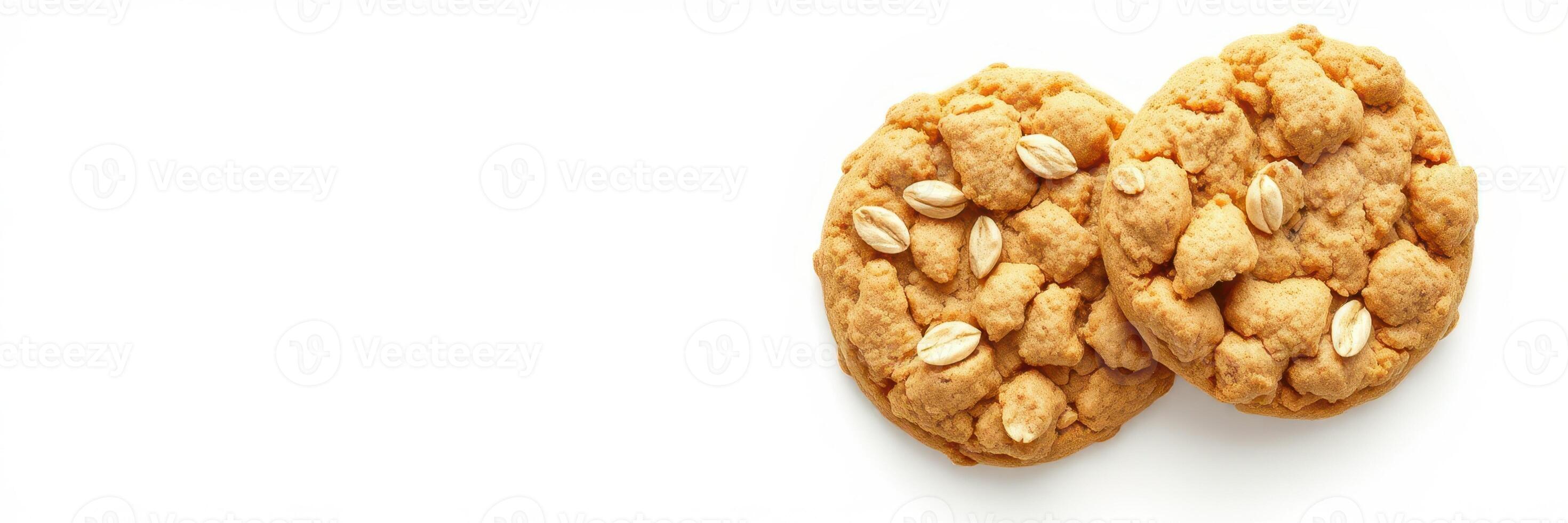 Freshly baked oatmeal cookies topped with oats on a white surface ready to be enjoyed photo