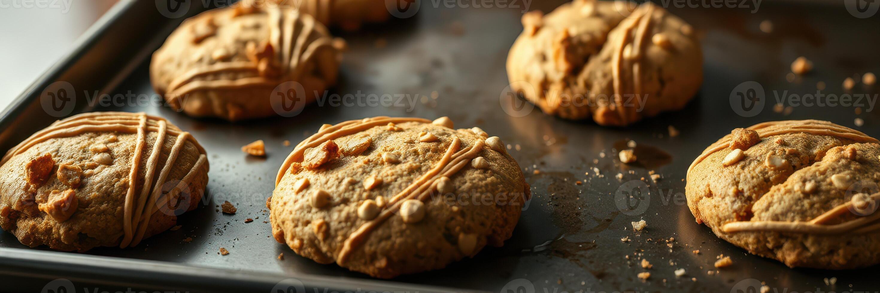 Freshly baked peanut butter cookies cooling on a baking tray by a window in a cozy kitchen photo