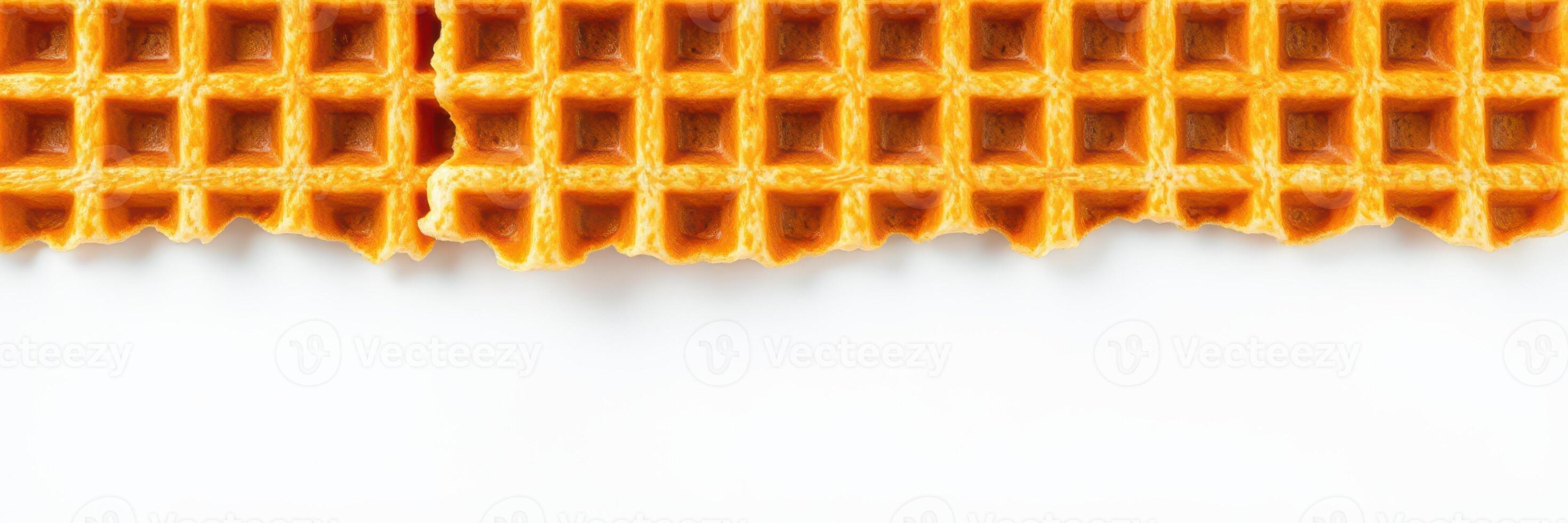 Crispy golden waffle with a bite taken out, highlighting its texture and layering details photo