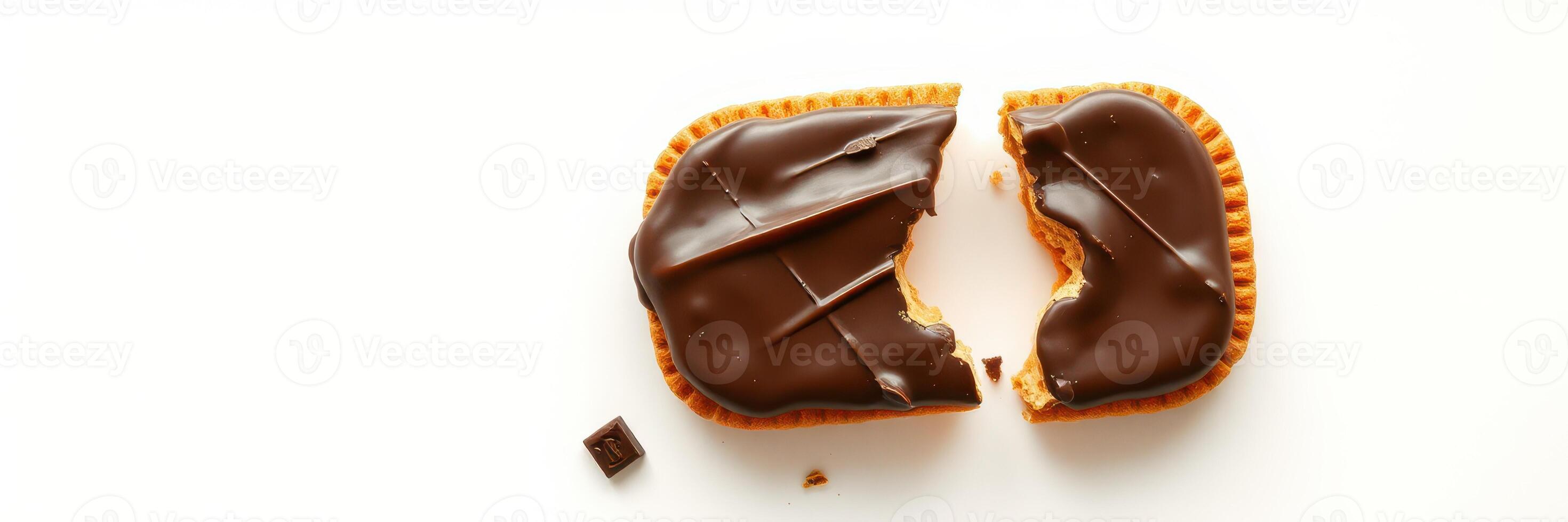 Chocolate covered biscuit broken in half showcasing the creamy filling and crunchy texture photo