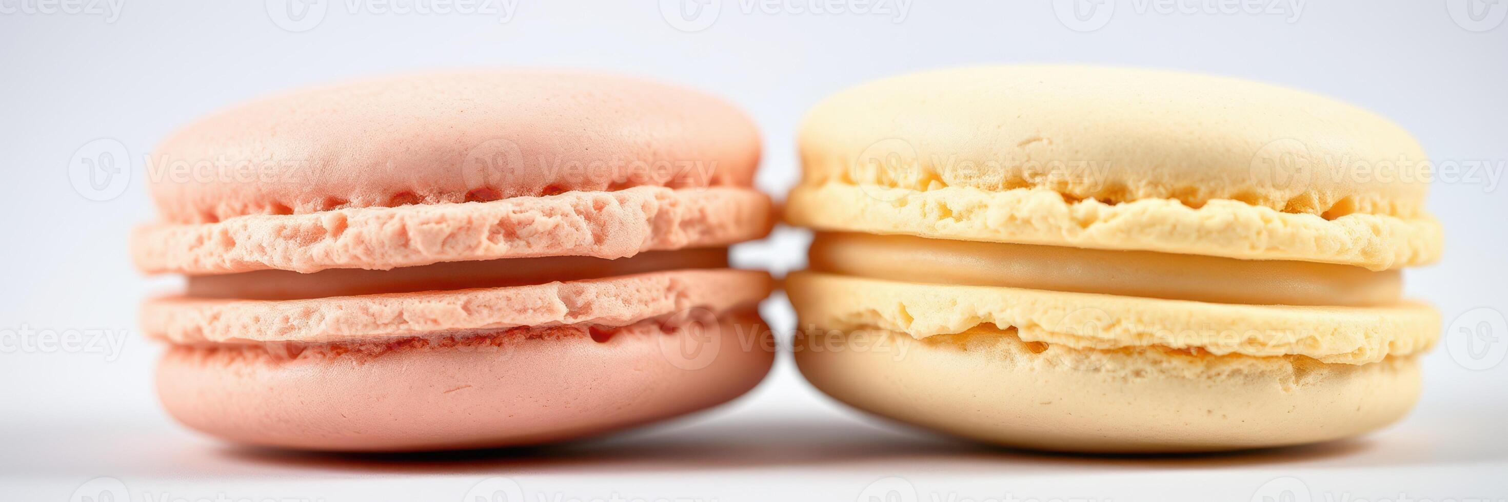 Colorful macarons in pink and yellow displayed together on a plain background highlighting their delicate texture and unique shapes photo