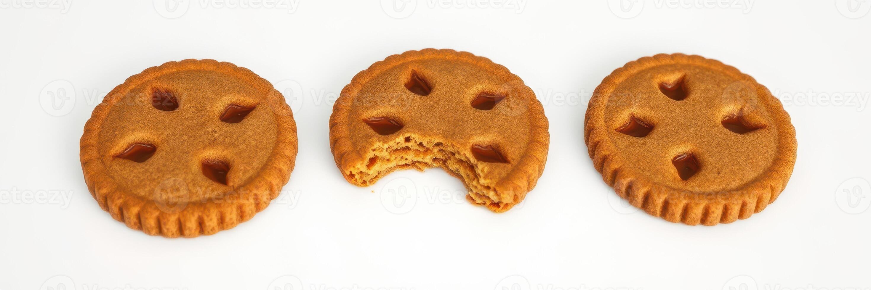 Cookies arranged in a row with one cookie missing a bite on a white background photo