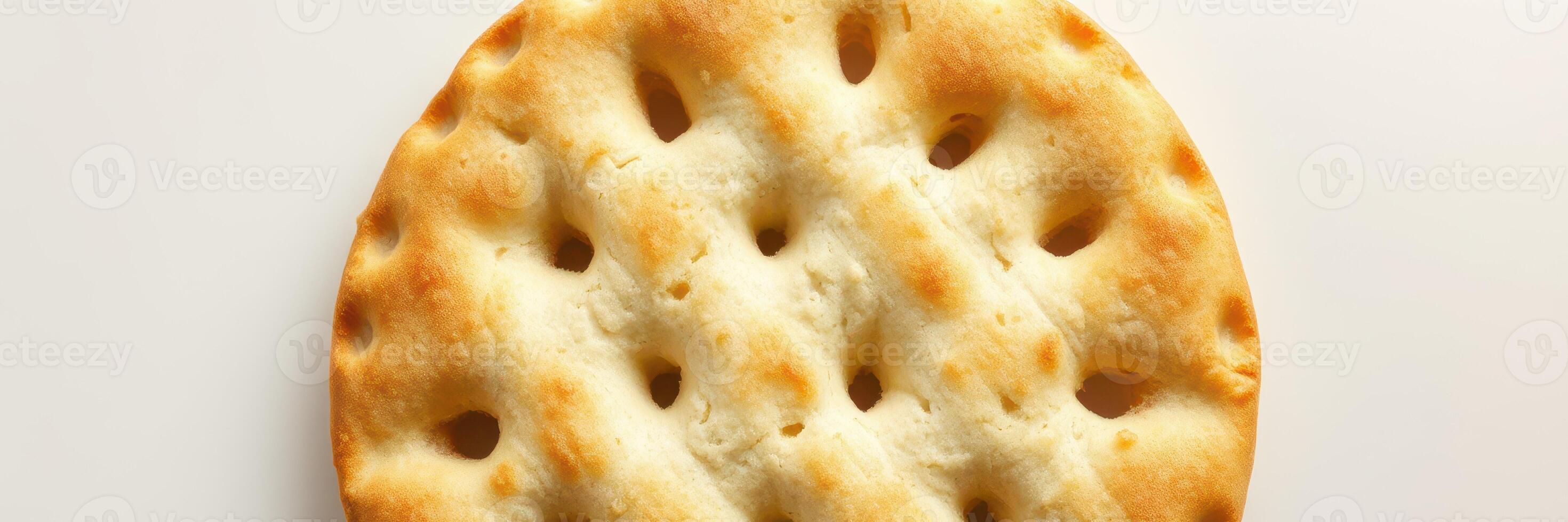 Deliciously baked cracker with a crispy texture and golden hue on a plain background photo