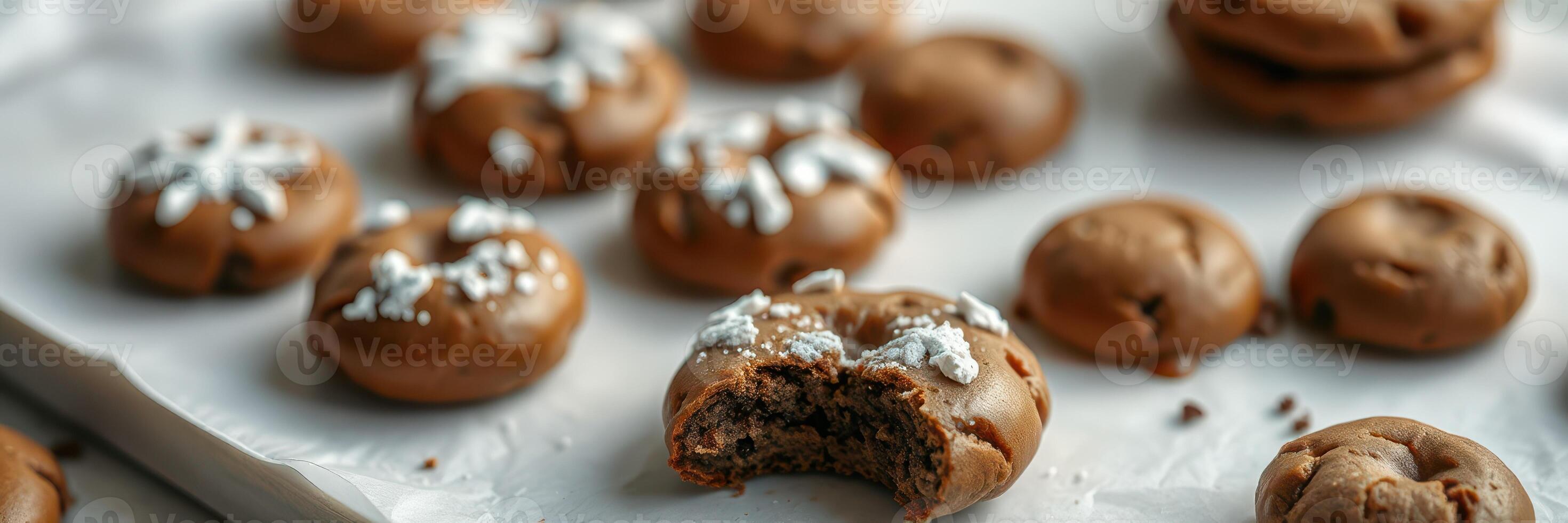 Delicious freshly baked cookies arranged on a table with one cookie taken a bite from photo