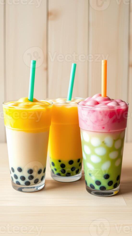 Colorful bubble tea drinks served in tall glasses with vibrant toppings and straws at a dessert cafe photo