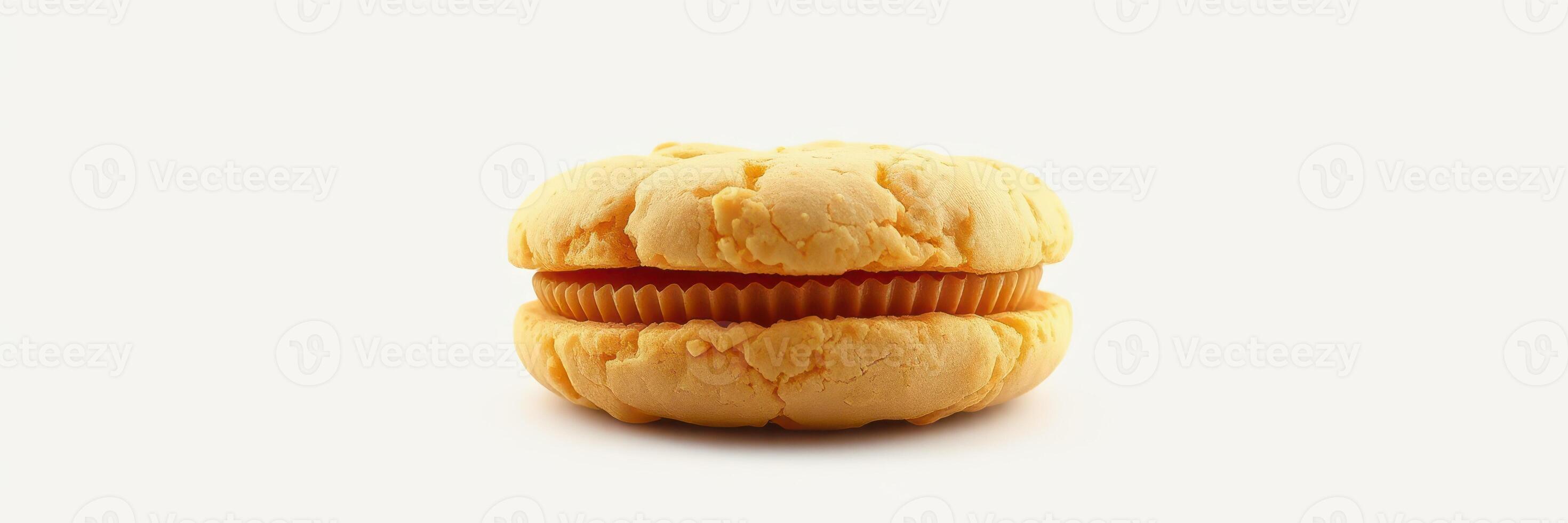 Unique orange dessert sandwich with cream filling displayed against a plain background photo