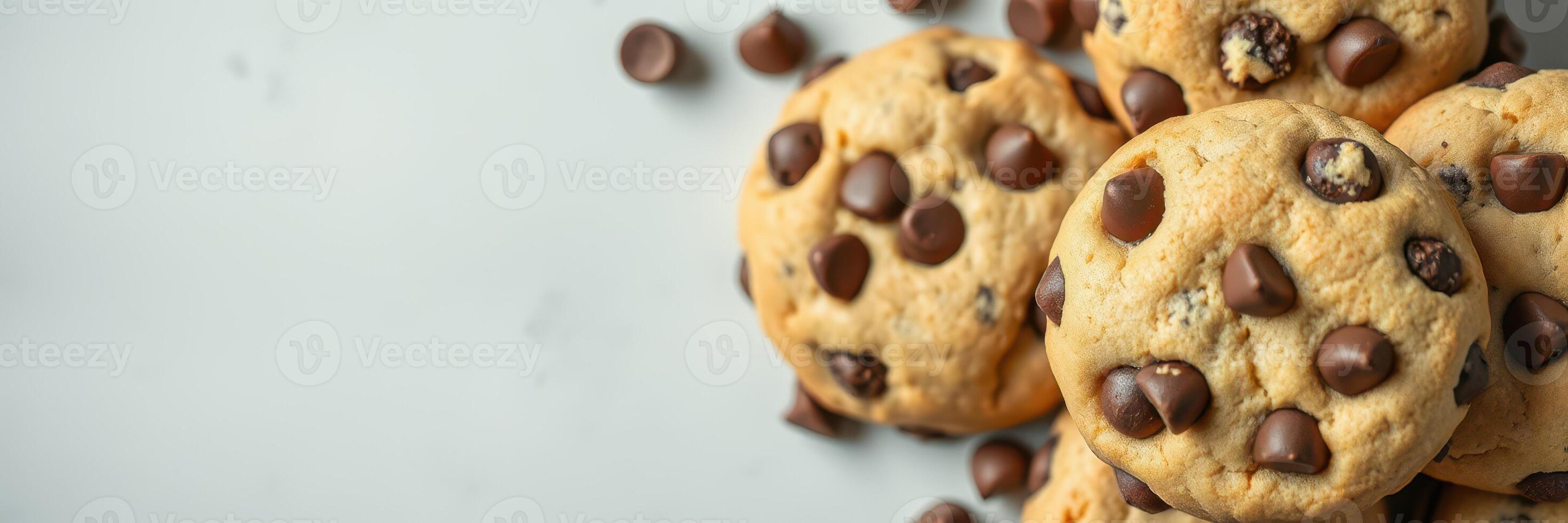 Freshly baked chocolate chip cookies on a light surface, perfect for sharing and enjoying at any time of day photo