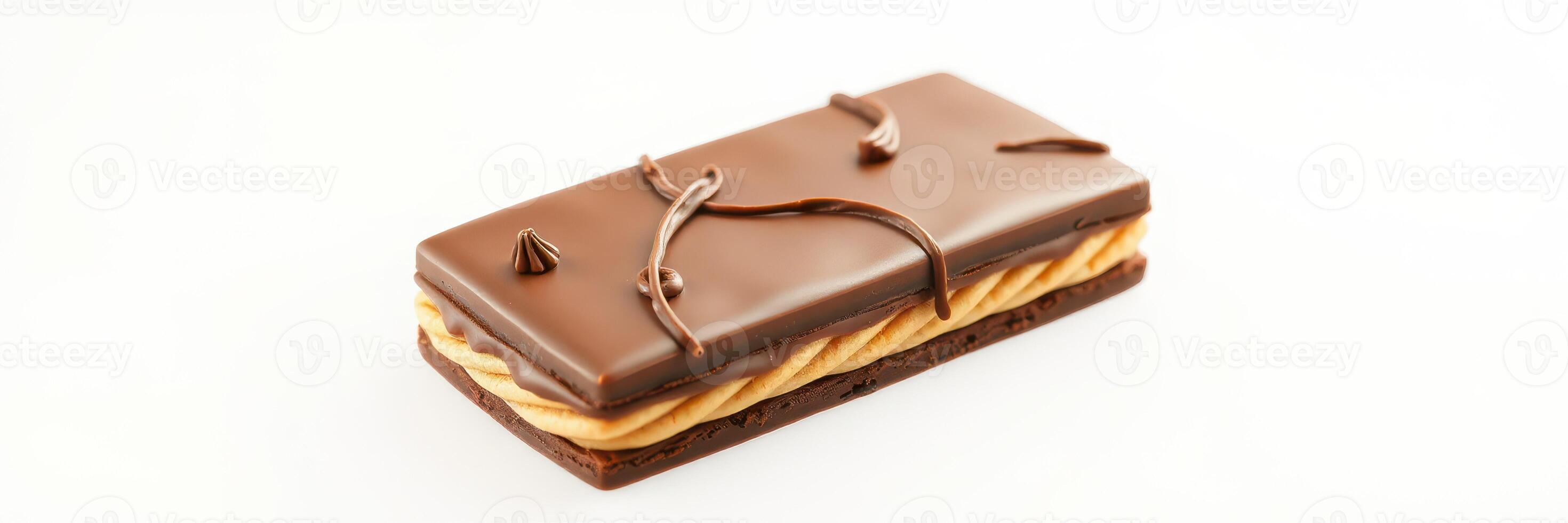 Delicious chocolate bar with creamy filling and decorative drizzles presented on a clean white background in a well-lit setting photo
