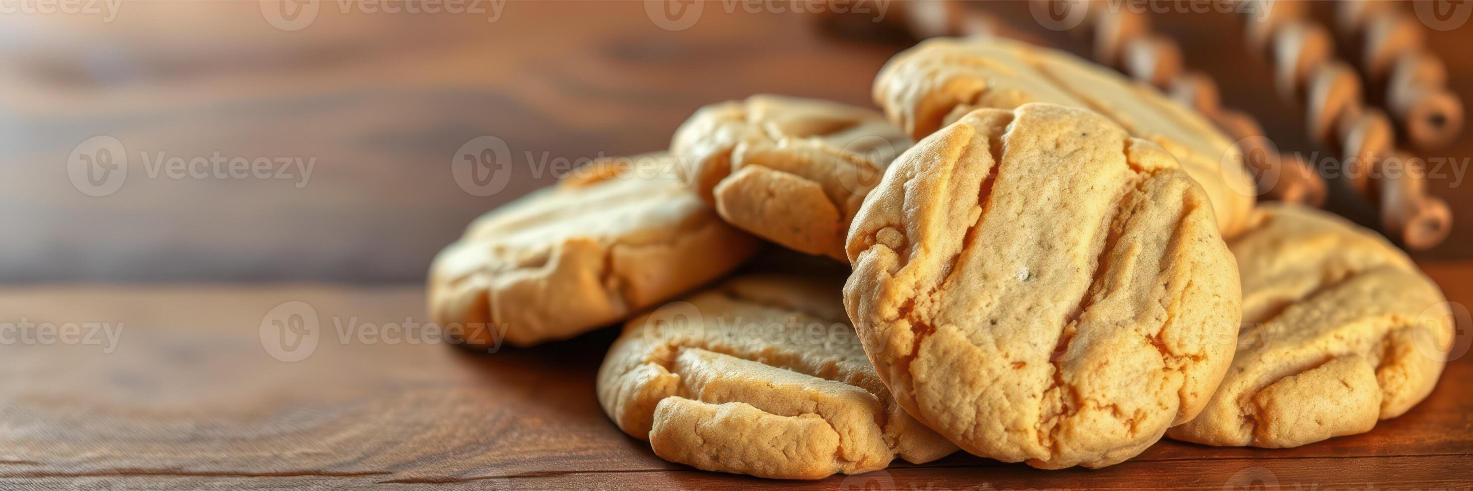 Delicious homemade cookies arranged on a wooden table with rustic kitchen utensils in the background photo
