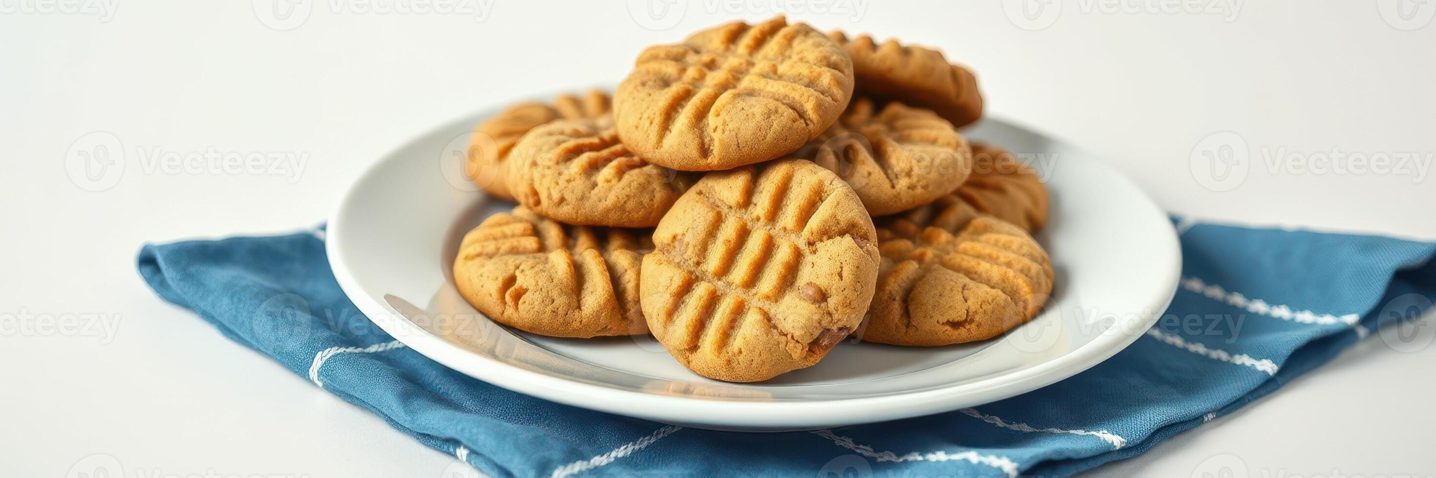 Freshly baked peanut butter cookies on a blue towel ready for serving photo