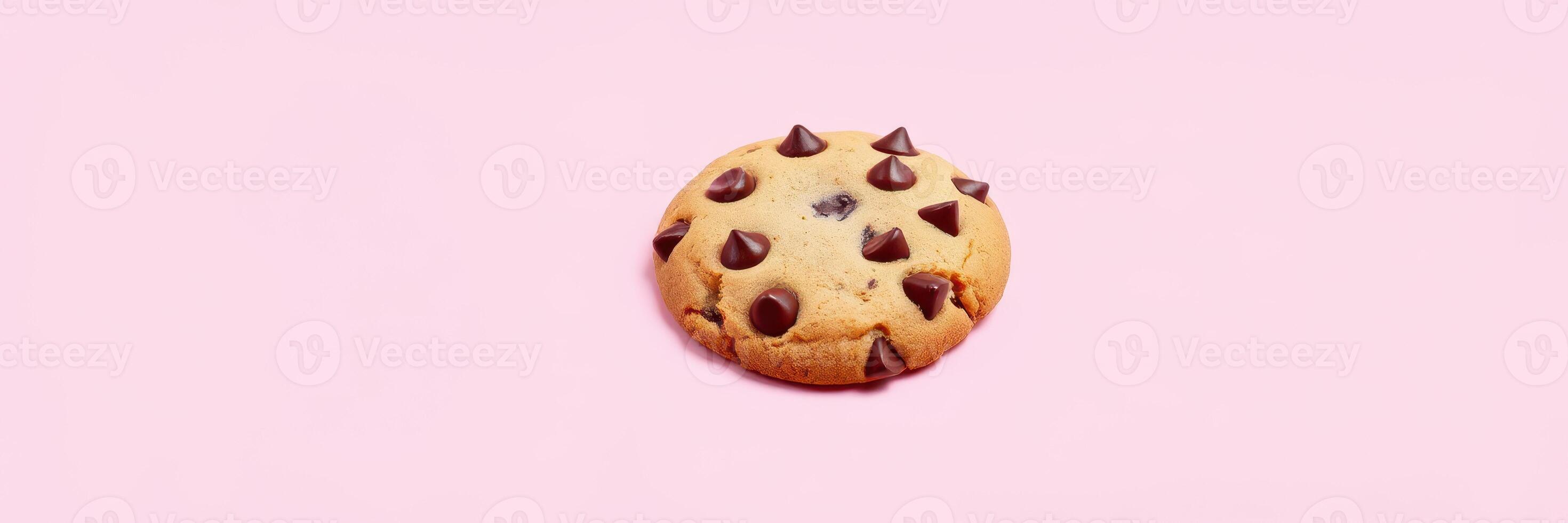 Soft chocolate chip cookie placed on a pastel pink background creating a whimsical dessert aesthetic photo