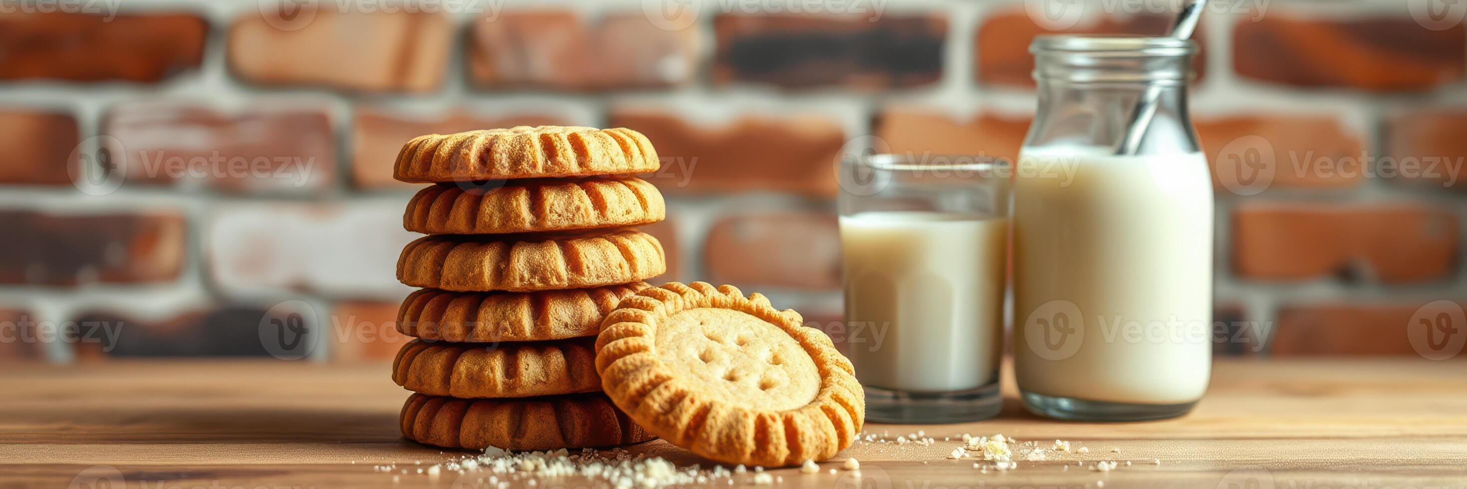 Delicious cookies paired with a glass of milk on a wooden table against a brick wall photo