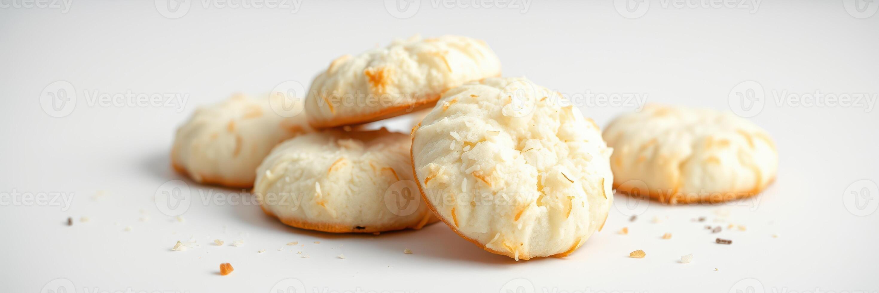 Coconut macaroons arranged on a plain surface ready for a dessert feast at a sunny kitchen photo