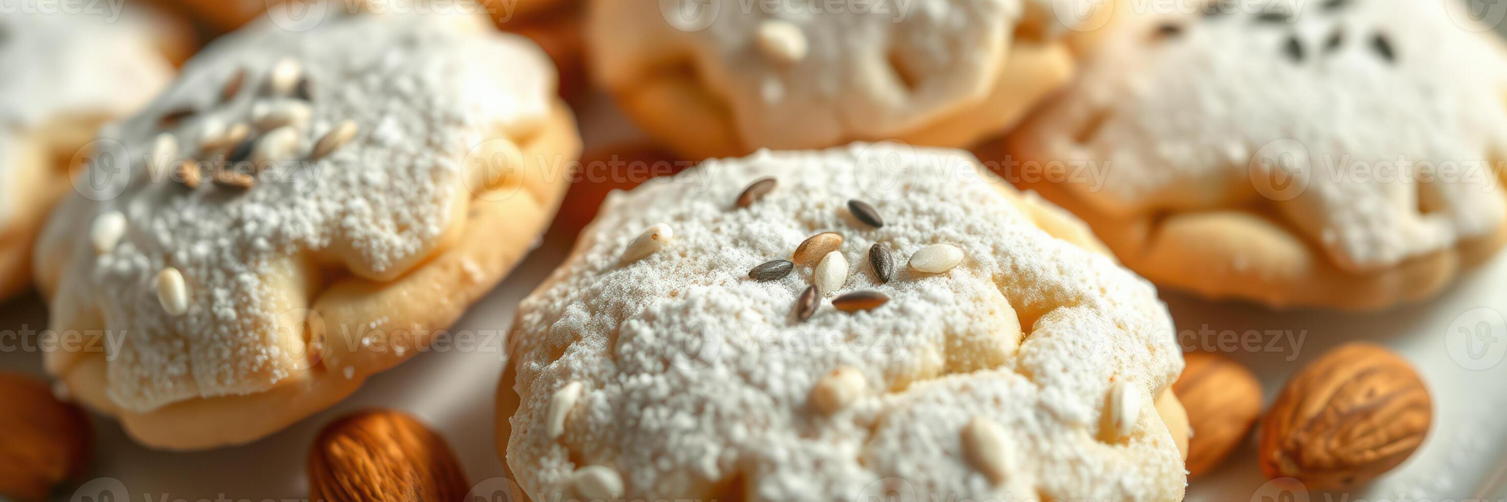 Delicate cookies topped with powdered sugar and seeds served on a white plate photo