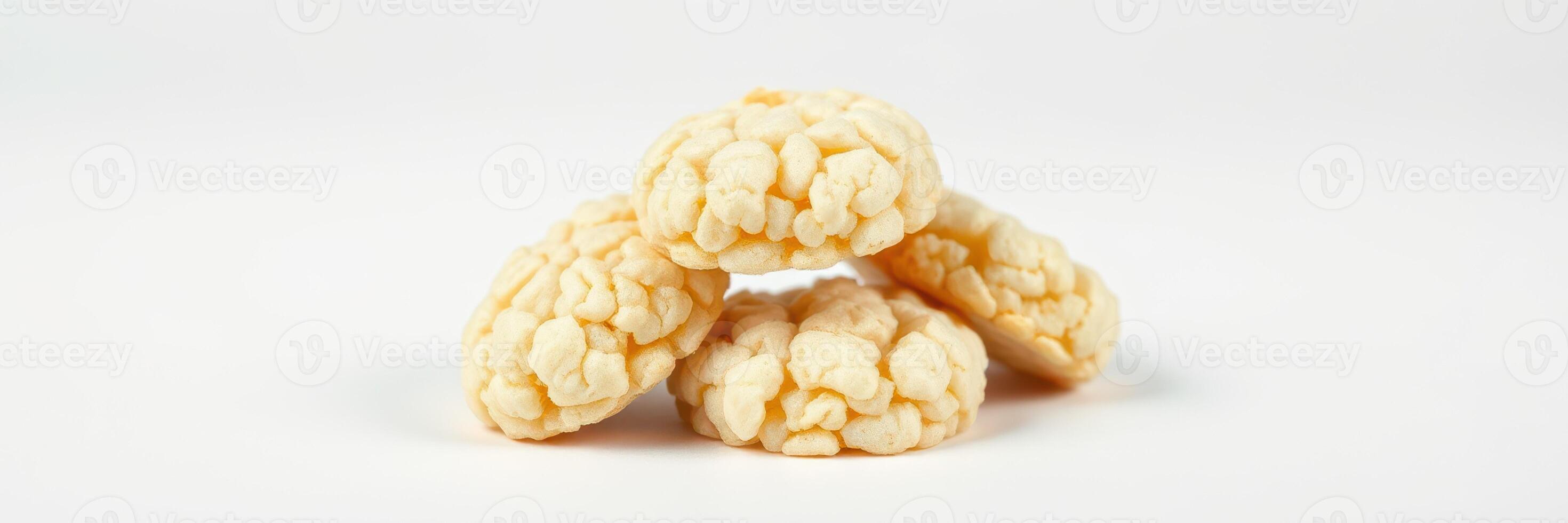 Popcorn-based snacks arranged in a pyramid shape on a plain background photo