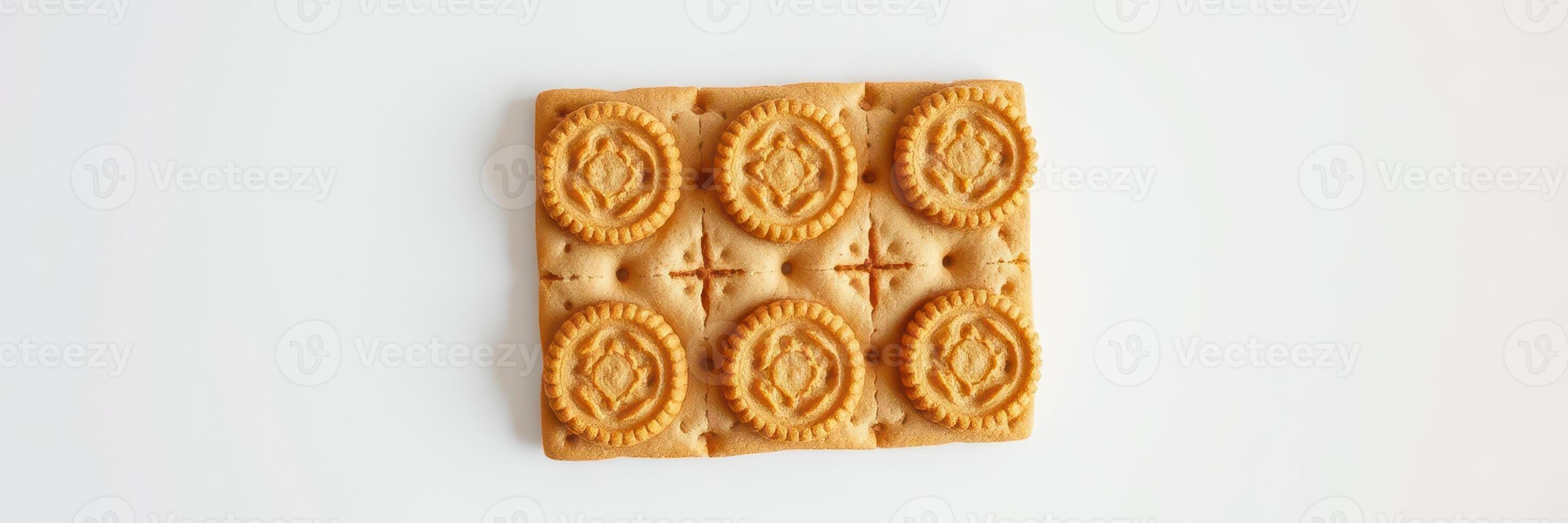 Delicious rectangular biscuit with intricate design on a neutral background, perfect for snacking or pairing with tea photo