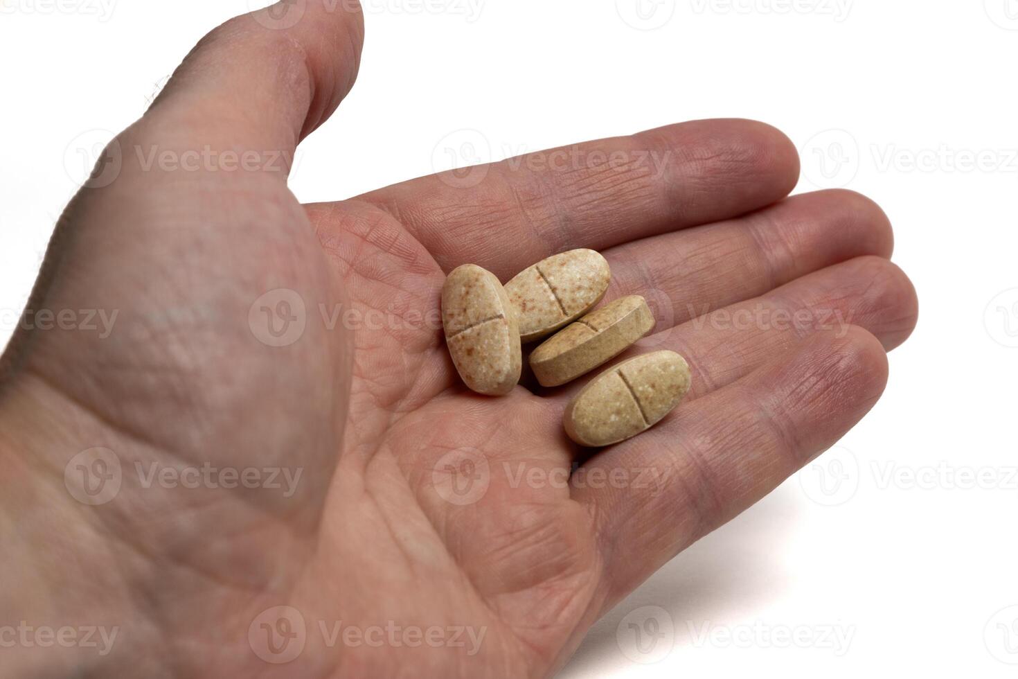 Drugs in a man hand isolated on white background. Tablets in a hand of human photo