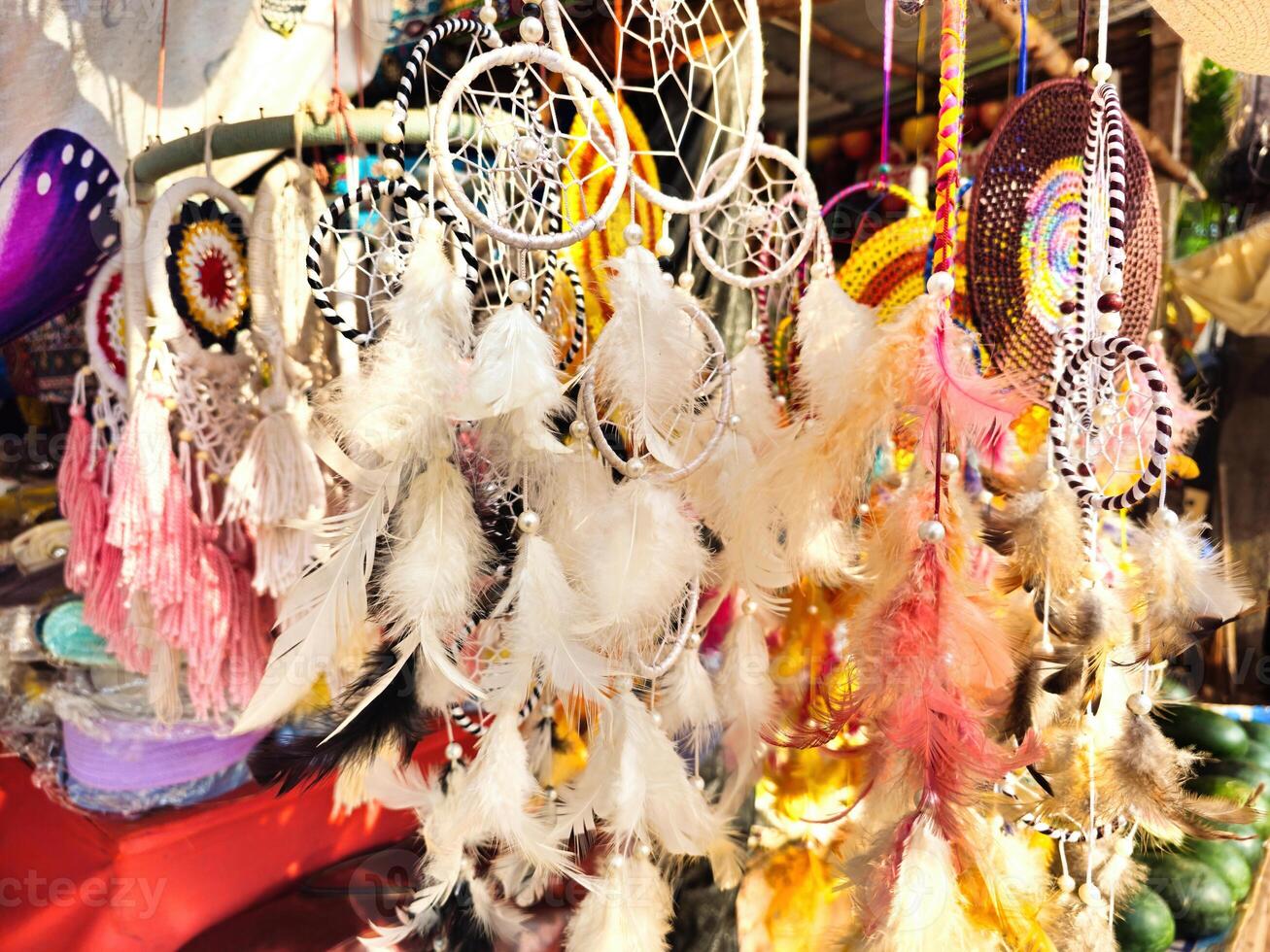 Goa India A display of dreamcatchers in various colors and designs, hanging in a market stall. photo