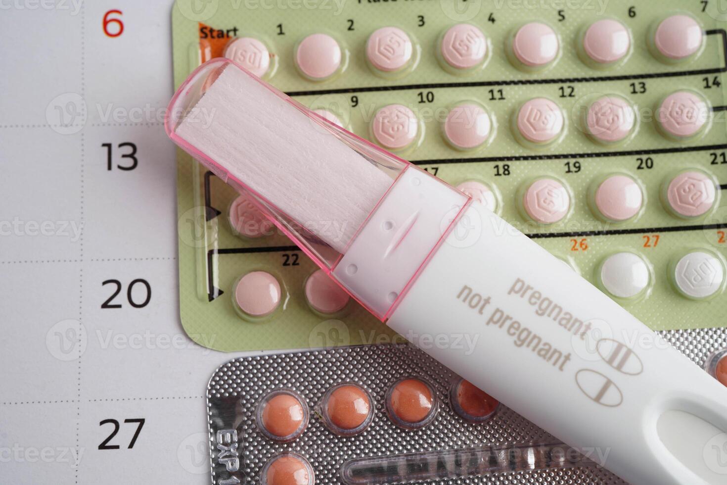 Pregnancy test with birth control pills for female of ovulation day, fetus, maternity, childbirth. photo