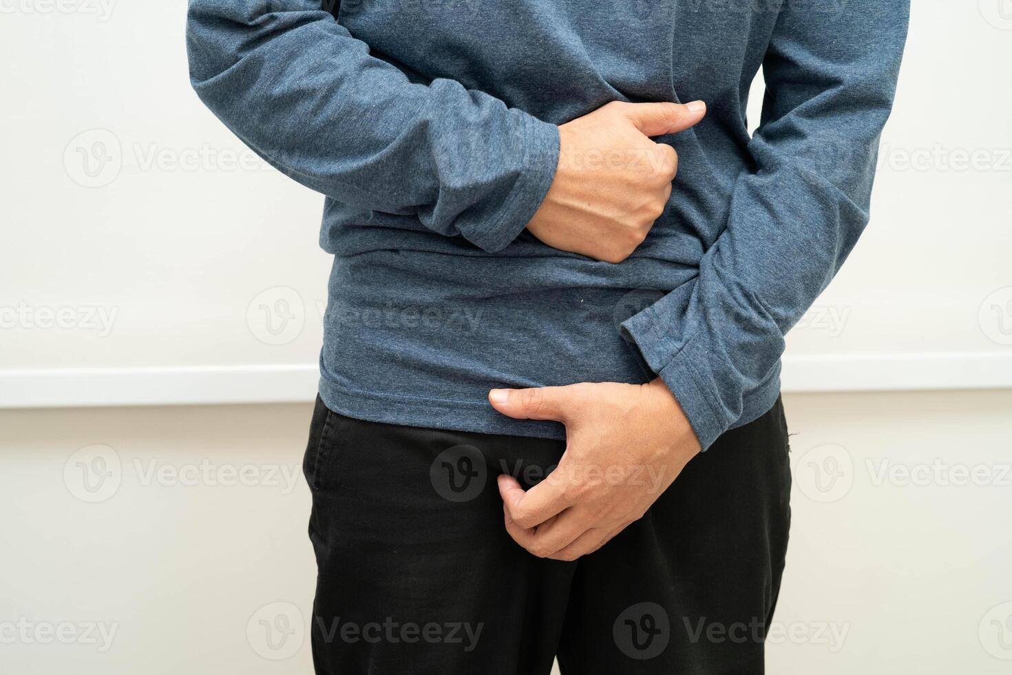 Hernia, Asian man stomach ache, abdominal pain and urology problem health. photo