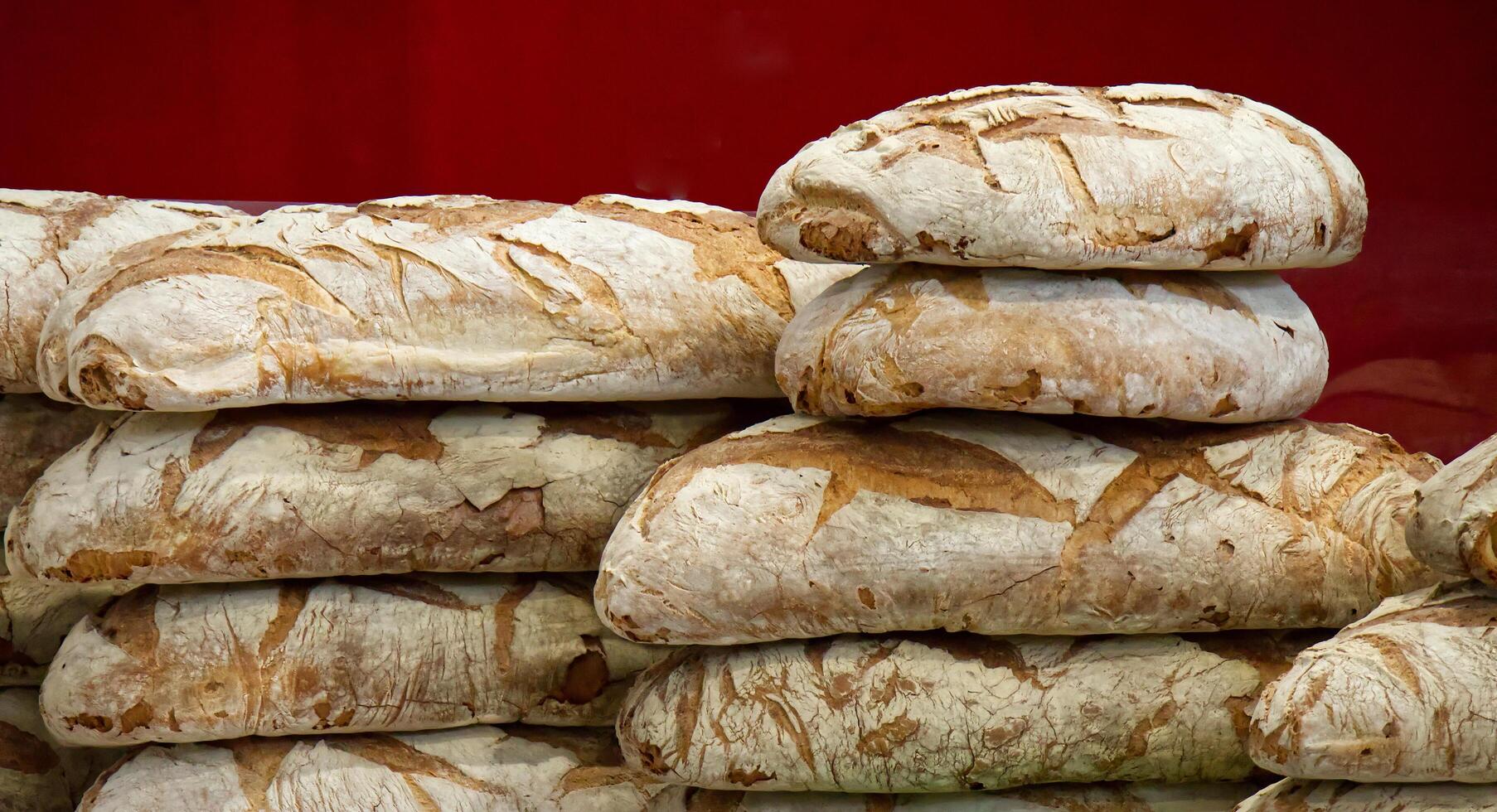 Stack of Italian Altamura artisanal loaves of bread, showcasing rustic texture. photo