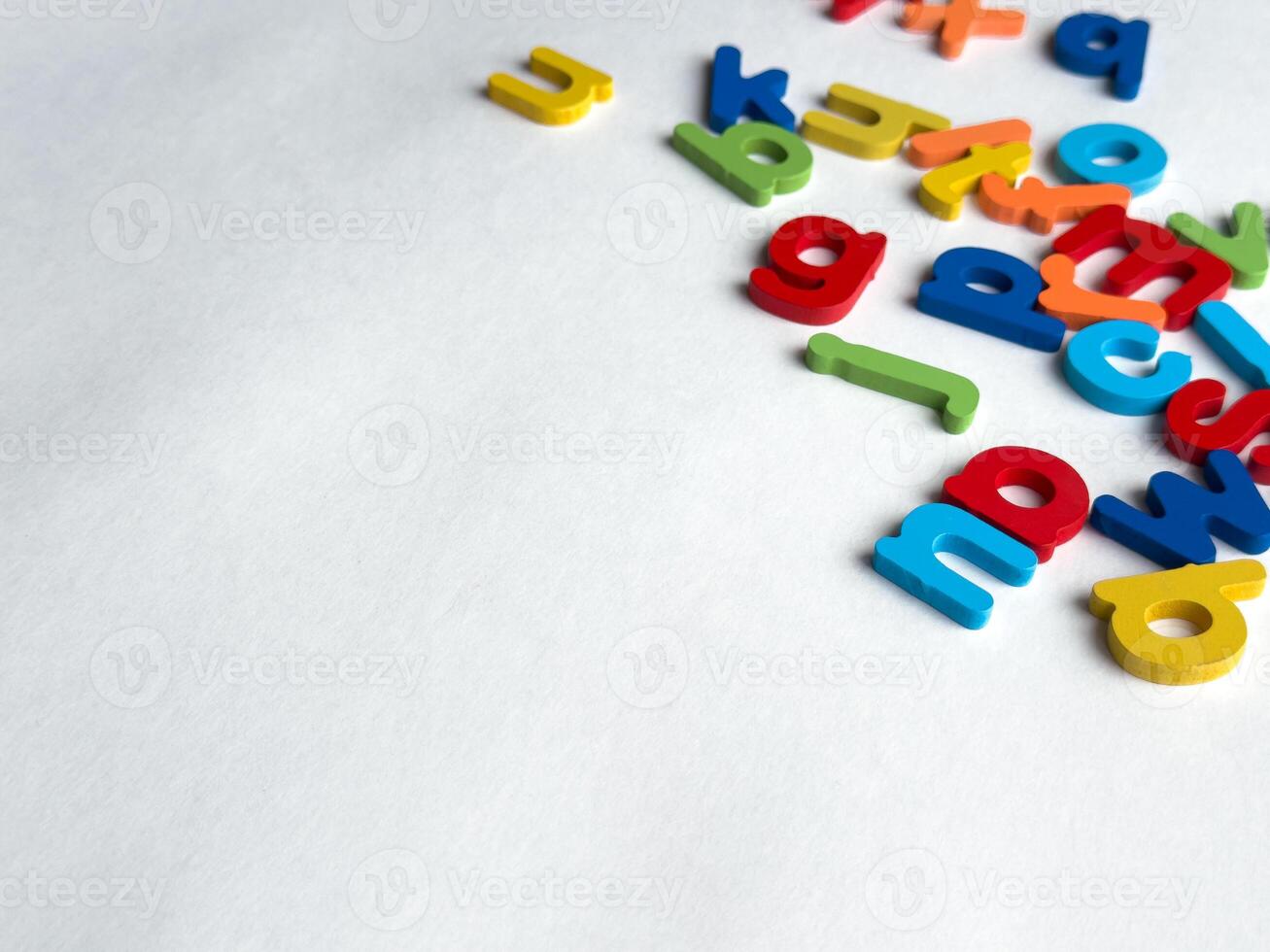 Colorful magnetic letters on white background for education and learning photo
