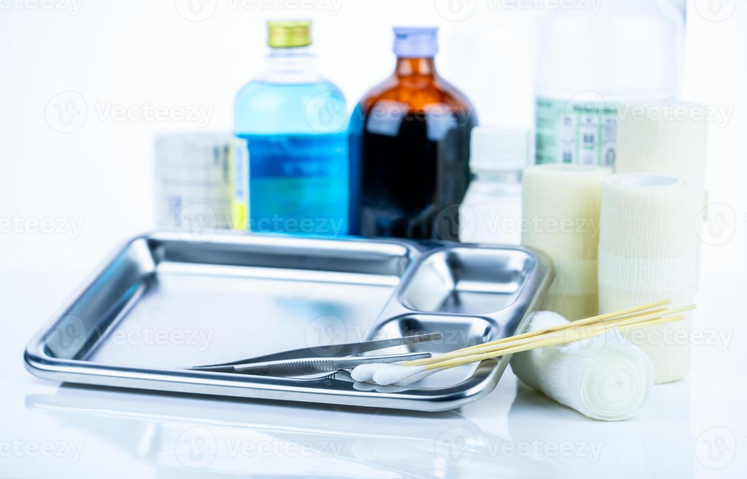 Medical equipment for treating infections. Wound care dressing set. Medical supplies for nurses. Conform bandage, forceps, cotton stick, alcohol. Sterile dressing materials. Healthcare equipment. photo