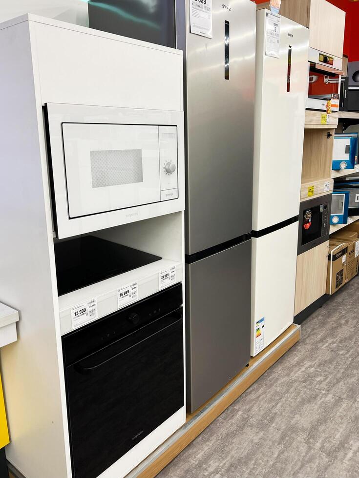 Kyiv, Ukraine - December 15, 2024 Modern Home Appliances on Display Including Microwave and Refrigerator photo