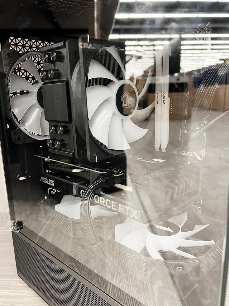 Kyiv, Ukraine - December 15, 2024 Modern desktop gaming PC with visible internal components through the side panel photo