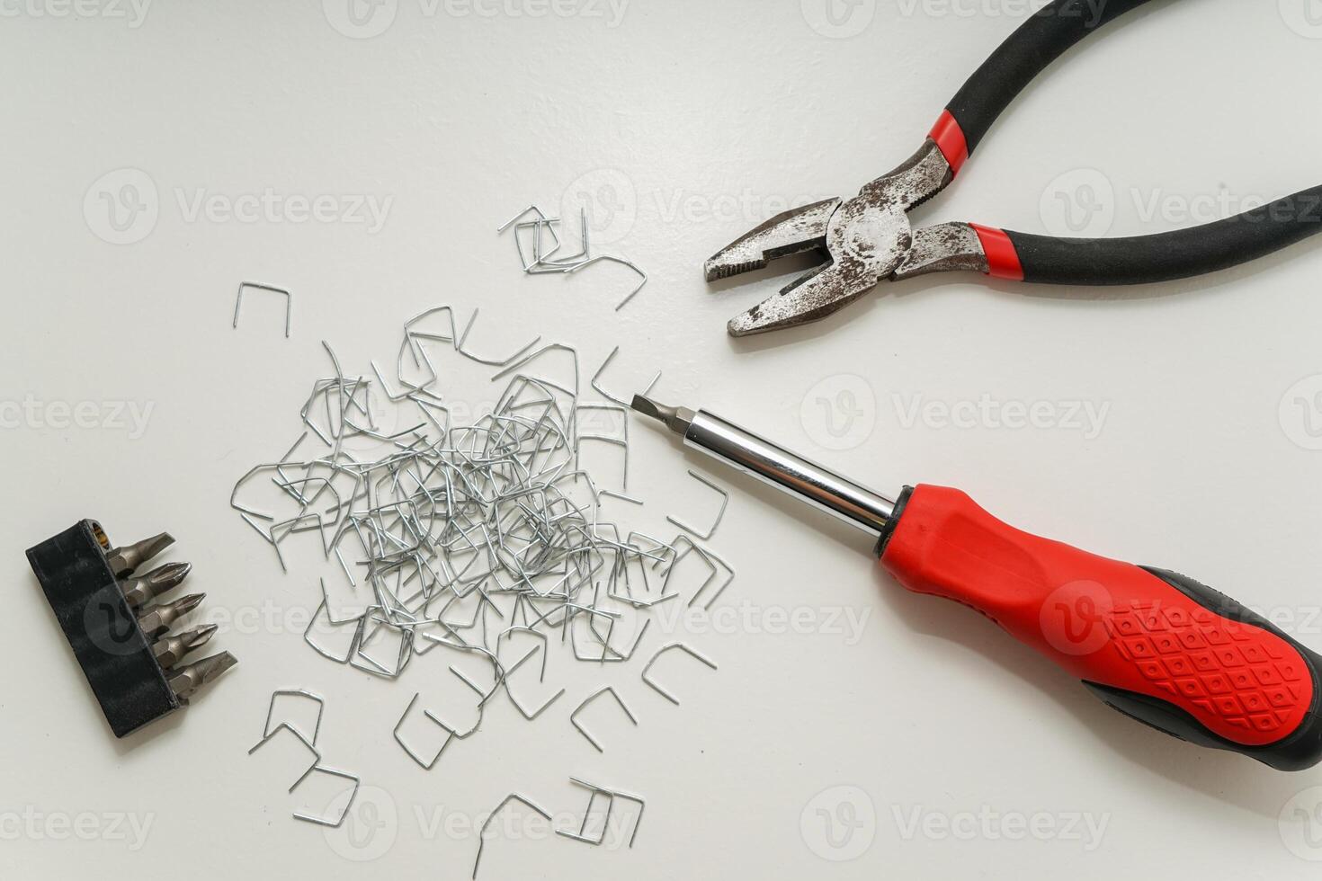 Tools and Staples on White Surface in Minimalist Composition with Copy Space photo