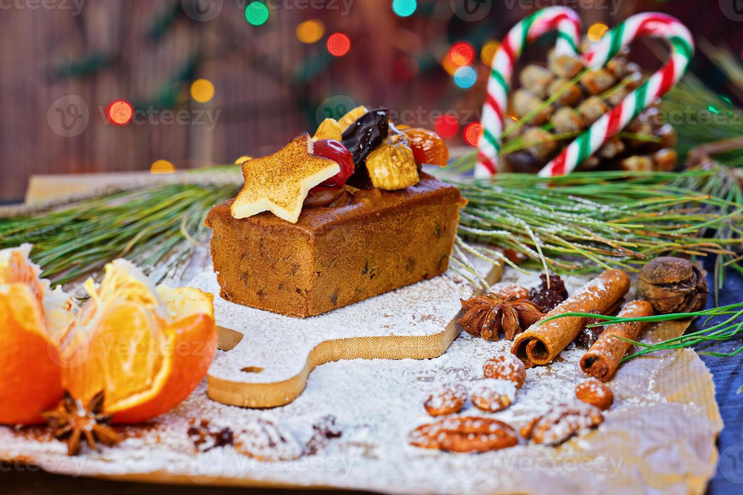 Christmas Fruit cake with Festive Toppings and Holiday Spices on Rustic Table photo