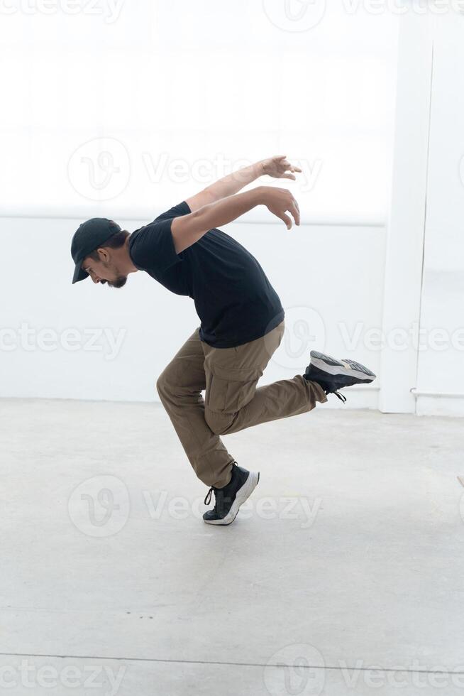 Happy dancing man enjoy practice break dance freestyle dance in building. Professional b-boy dancer photo