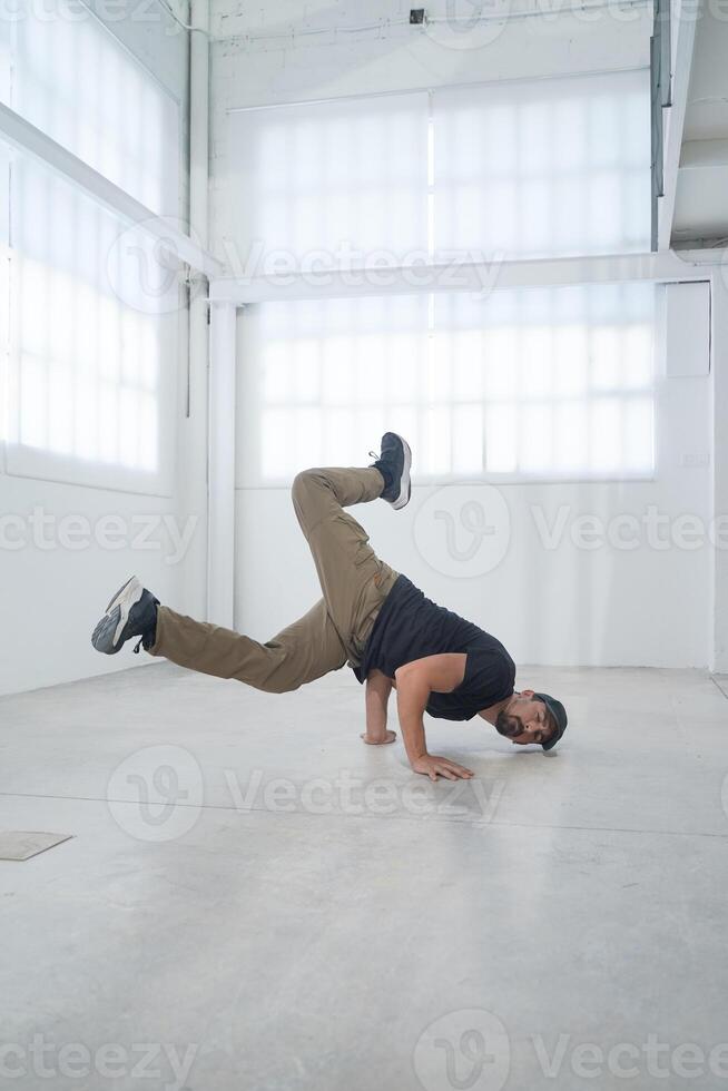 Happy man enjoy practice break dance freestyle. Professional b-boy dancer perform energetic movement photo