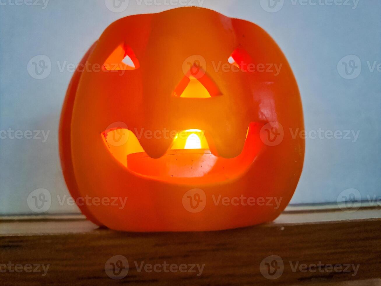 Pumpkin with lighted candles and lanterns for a Haloween holiday photo