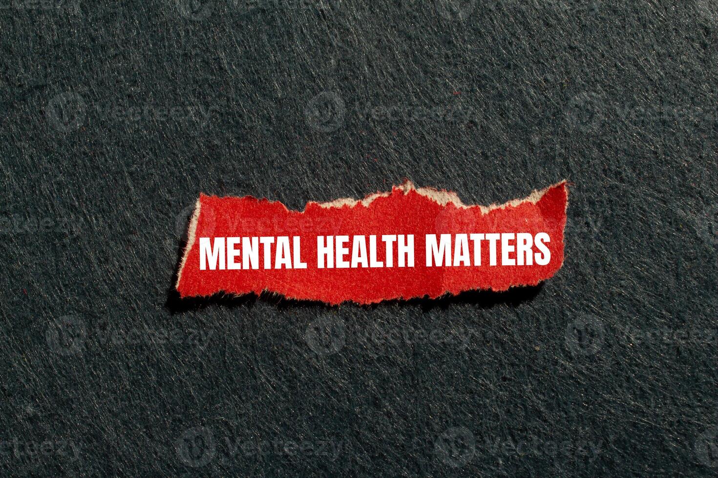Mental health matters message written on ripped torn red paper piece with gray background. Conceptual mental health matters symbol. Copy space. photo