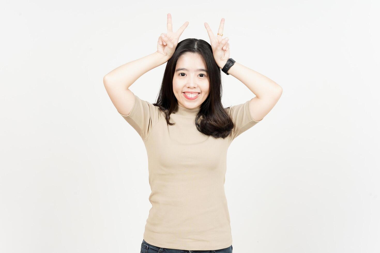 Showing Peace Sign Of Beautiful Asian Woman Isolated On White Background photo