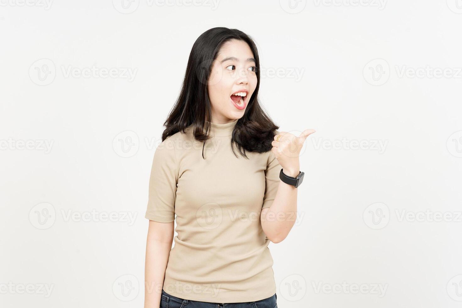 Presenting and Pointing Side Product Using Thumb Of Beautiful Asian Woman Isolated On White photo