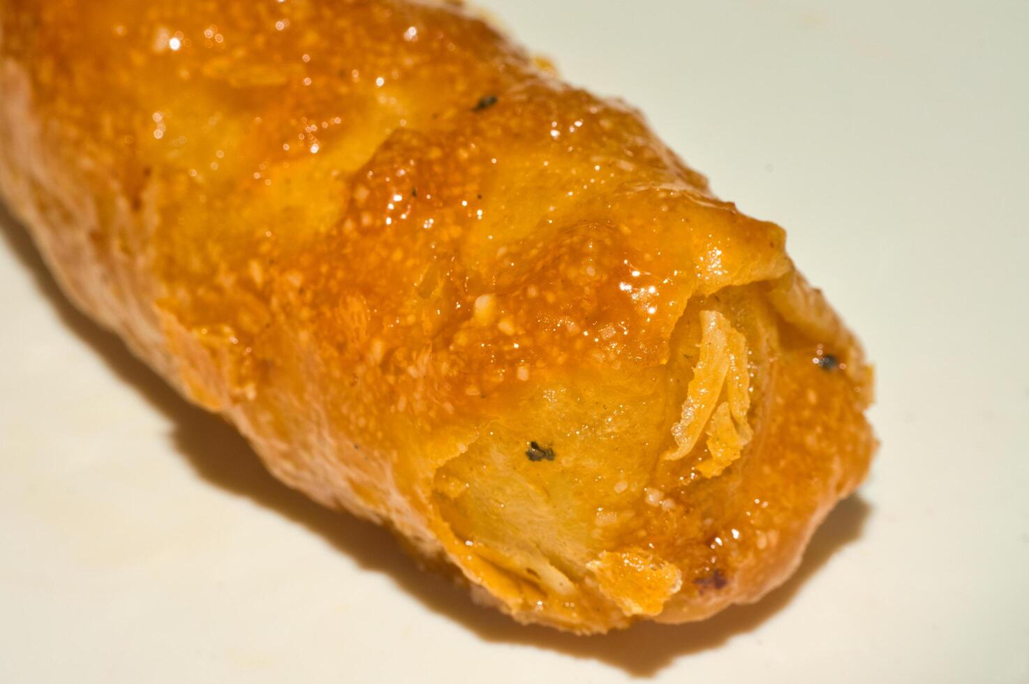 a close up of a spring roll covered with sugar photo
