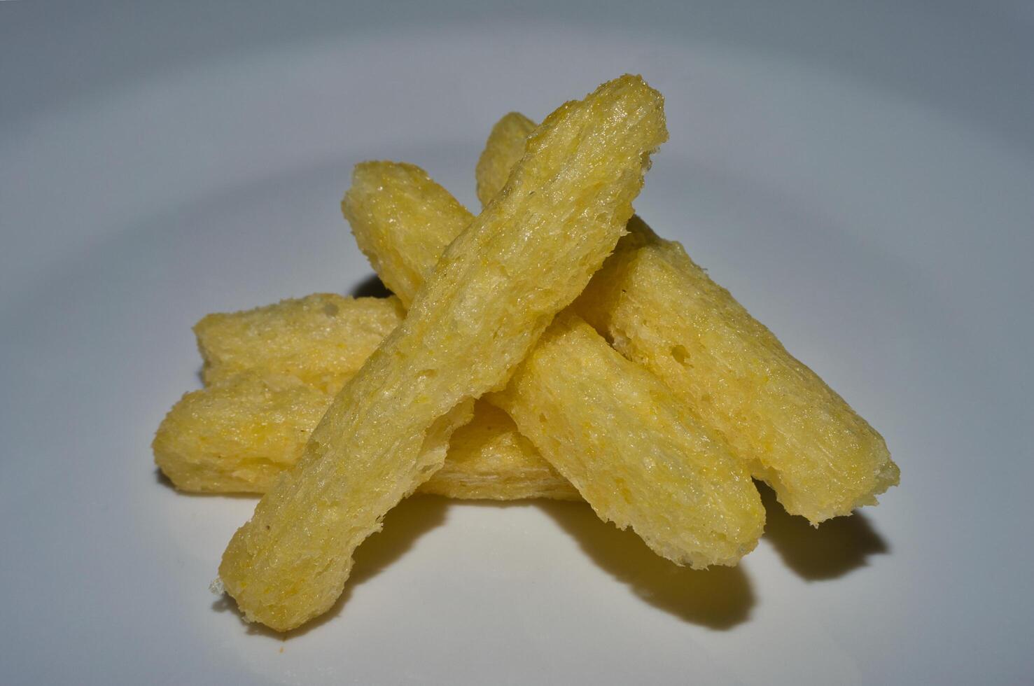 a white plate with some fried potato sticks photo