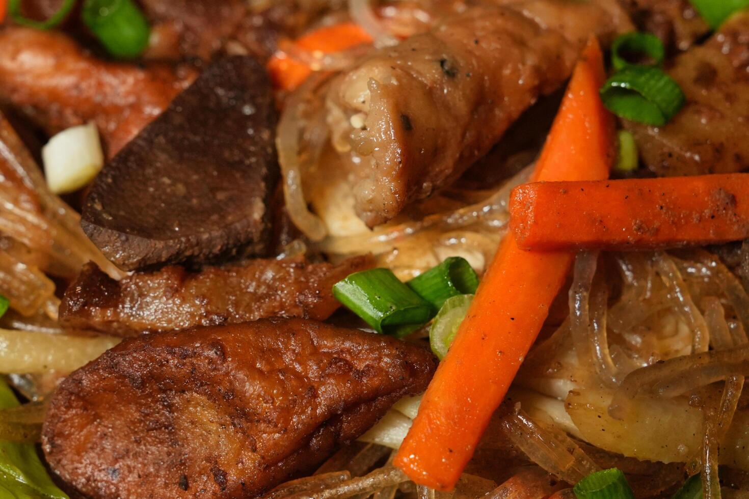 a plate of food with meat, vegetables and onions photo