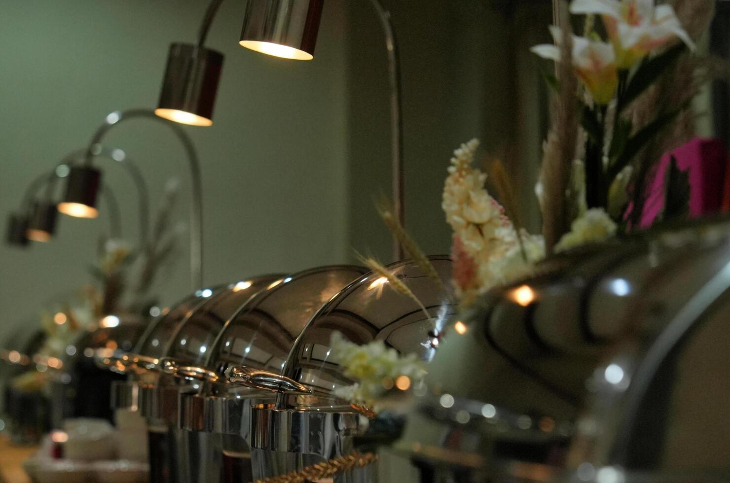 a long line of silver pots and pans on a table photo